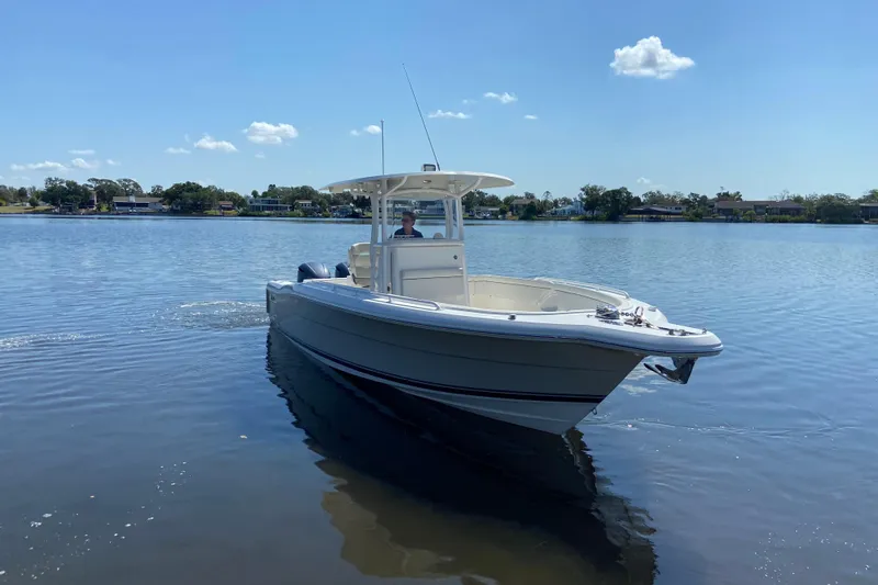Slide: The Image of 2017 Stamas 317 Tarpon boat cruising on a calm lake under a clear blue sky. - 8