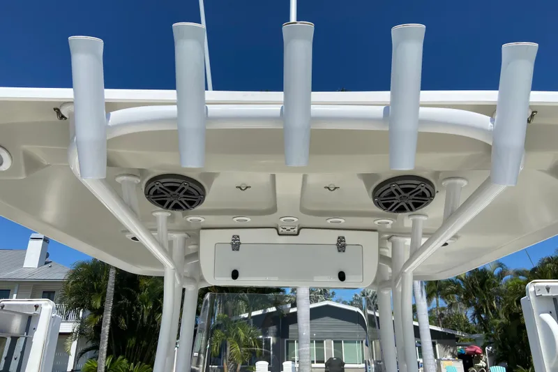 Slide: The Image of 2017 Stamas 317 Tarpon boat roof with rod holders and speakers under clear blue sky. - 25