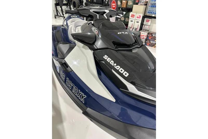 Slide: The Image of 2023 Sea-Doo GTX 230 jet ski in showroom, featuring sleek design and branding. - 13