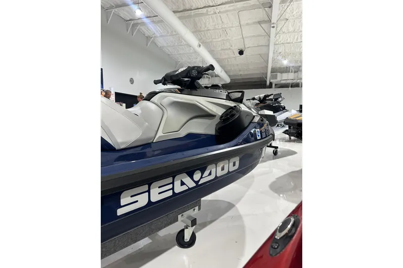 Slide: The Image of 2023 Sea-Doo GTX 230 jet ski displayed in a showroom, featuring sleek design. - 11