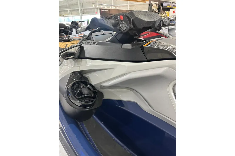 Slide: The Image of 2023 Sea-Doo GTX 230 jet ski handlebar and speaker detail in showroom. - 7