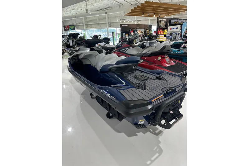 The Image of 2023 Sea-Doo GTX 230 jet ski displayed in a showroom. - 4