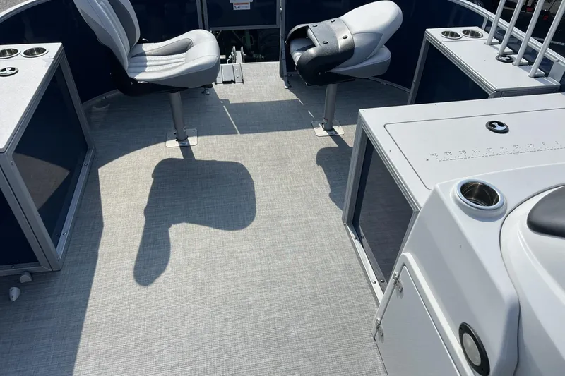 Slide: The Image of 2024 Lowe SF 214 Sport Fish boat interior with seating and fishing rod holders. - 7