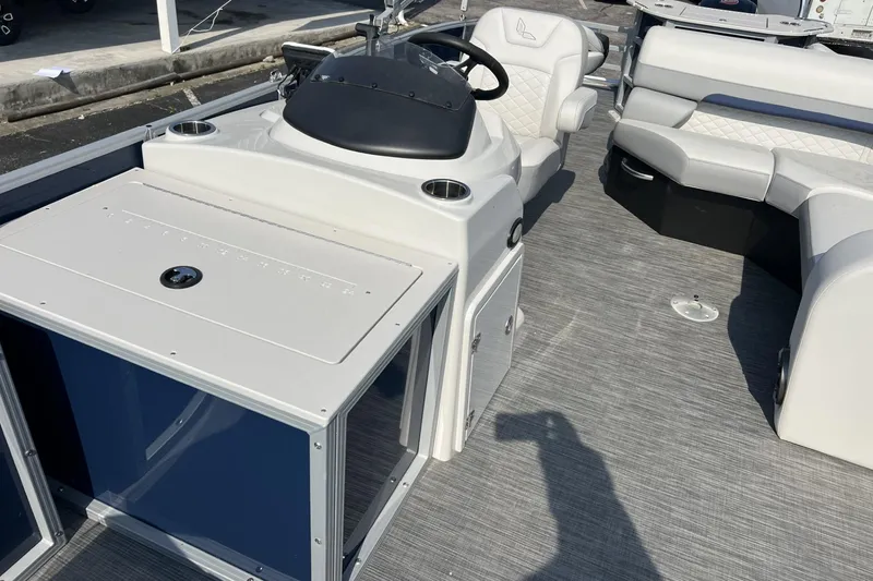 Slide: The Image of 2024 Lowe SF 214 Sport Fish boat interior with steering console and seating area. - 4