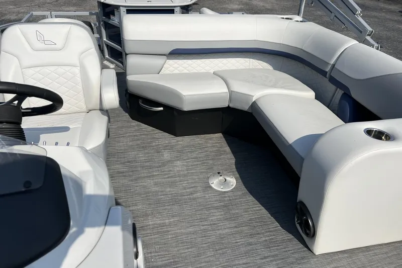 Slide: The Image of 2024 Lowe SF 214 Sport Fish boat interior with white cushioned seating and steering area. - 5