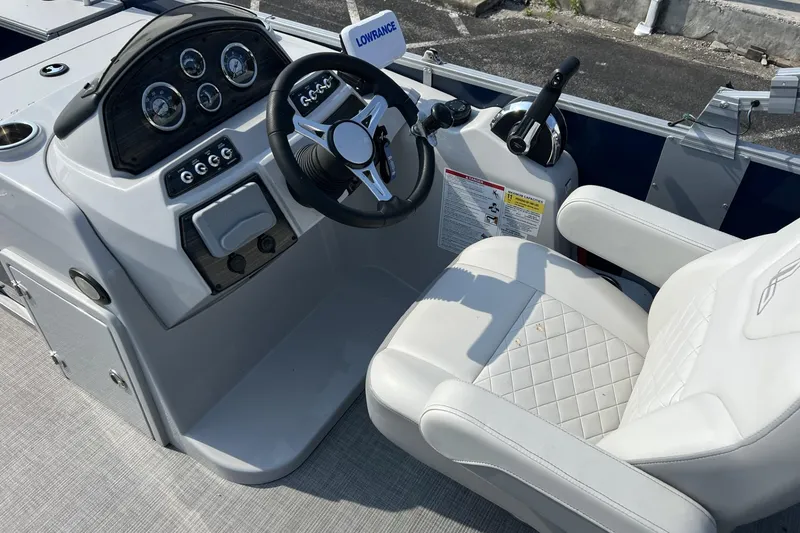 Slide: The Image of 2024 Lowe SF 214 Sport Fish boat cockpit with steering wheel and control panel. - 6