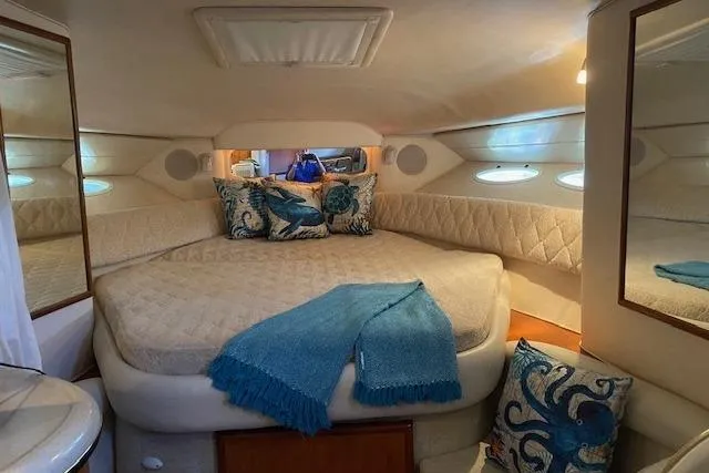 Slide: The Image of Luxurious cabin interior of 2001 Sea Ray 340 Sundancer with cozy bedding and nautical decor. - 17