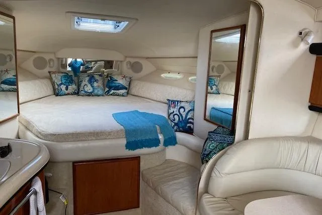 Slide: The Image of Interior of 2001 Sea Ray 340 Sundancer with cozy bed and nautical decor. - 16