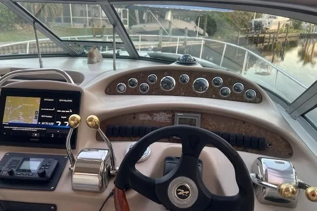 Slide: The Image of Helm of 2001 Sea Ray 340 Sundancer with navigation controls and gauges. - 4