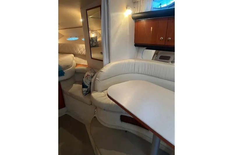 Slide: The Image of Interior of 2001 Sea Ray 340 Sundancer yacht with plush seating and wooden cabinetry. - 14