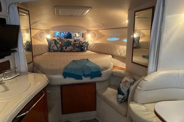 Slide: The Image of Luxurious interior of a 2001 Sea Ray 340 Sundancer yacht with cozy bedding and elegant decor. - 15