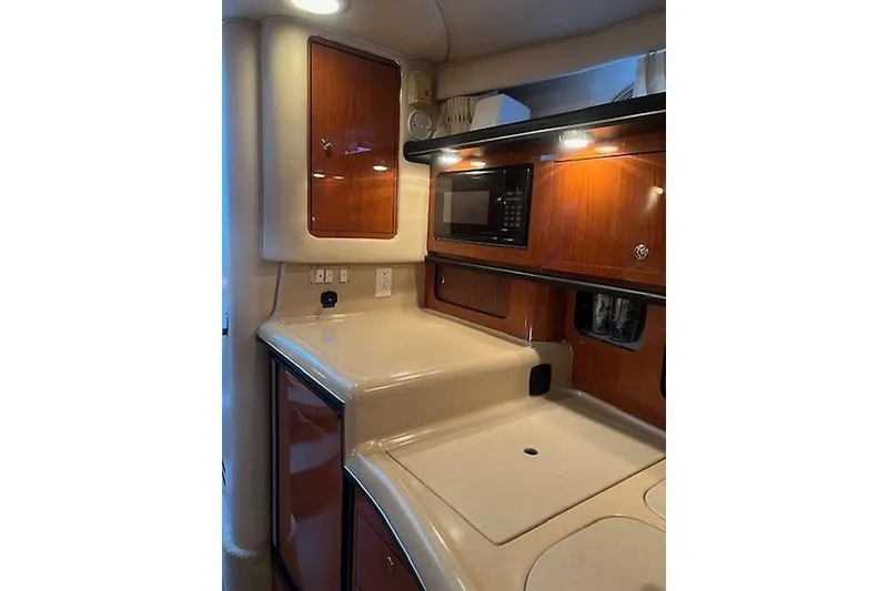 Slide: The Image of Interior of 2001 Sea Ray 340 Sundancer yacht kitchen with wood cabinets and microwave. - 11