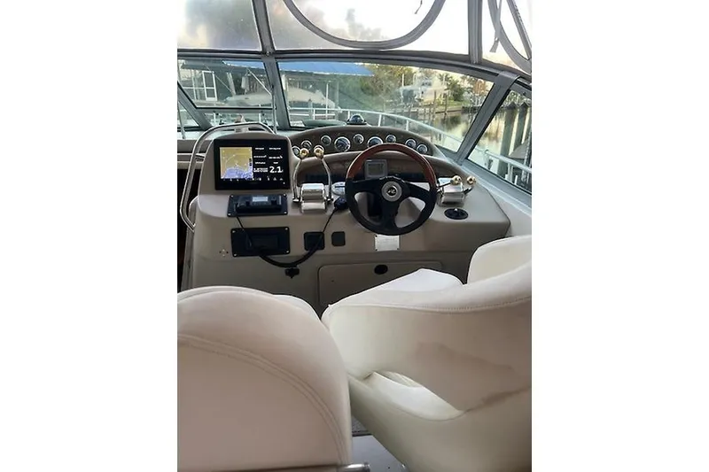 Slide: The Image of Helm of 2001 Sea Ray 340 Sundancer with navigation equipment and steering wheel. - 5