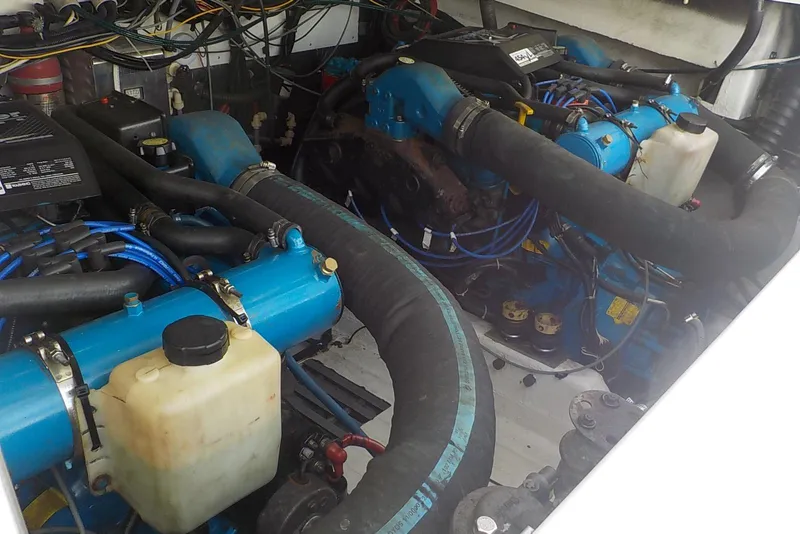 Slide: The Image of Engine compartment of a 1996 Pursuit 3000 Offshore boat, showcasing dual engines and wiring. - 22