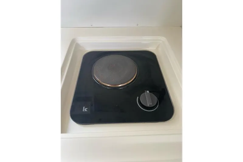Slide: The Image of Electric stove burner on 1996 Pursuit 3000 Offshore boat kitchen. - 10