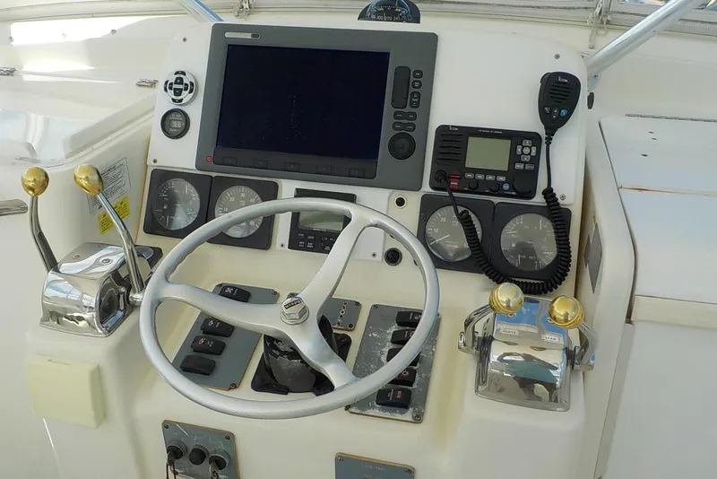 Slide: The Image of Control panel of a 1996 Pursuit 3000 Offshore boat with steering wheel and gauges. - 5