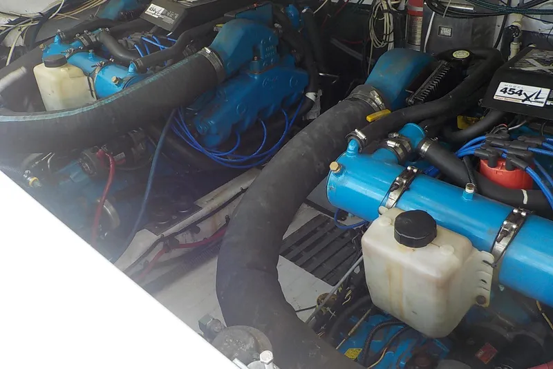Slide: The Image of Twin engines in a 1996 Pursuit 3000 Offshore boat, showcasing detailed mechanical components. - 20