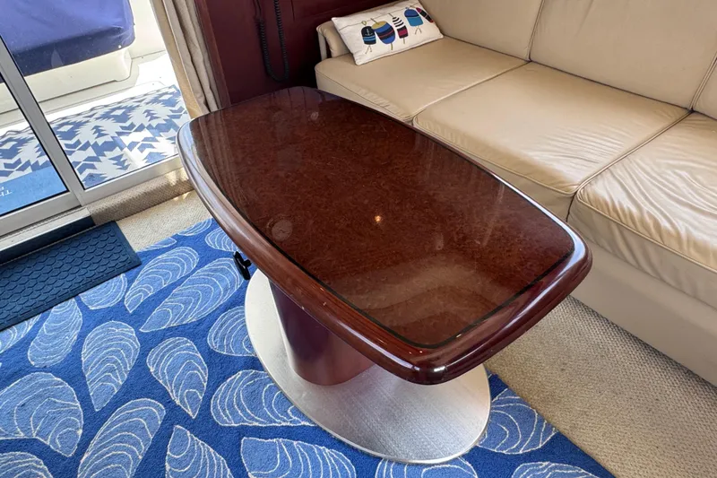 Slide: The Image of Luxurious interior of 2006 Sea Ray 44 Sedan Bridge with elegant wooden table and plush seating. - 25