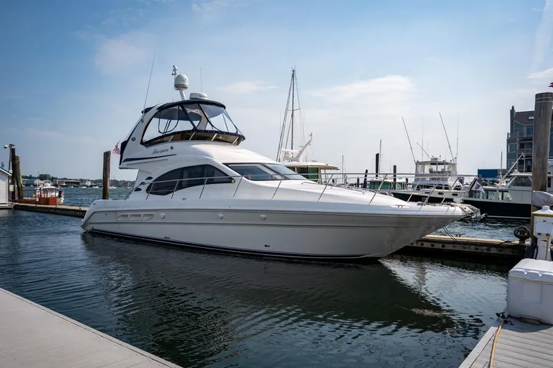 Slide: The Image of 2006 Sea Ray 44 Sedan Bridge yacht docked at marina under clear sky. - 49