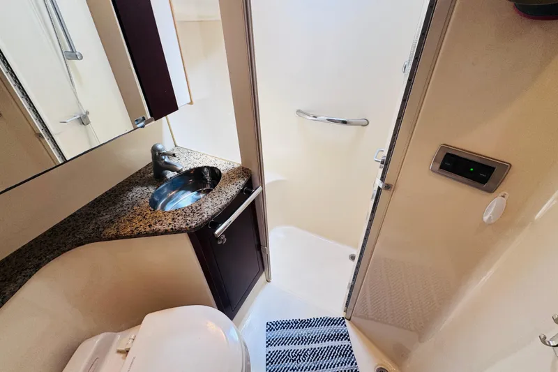 Slide: The Image of Luxurious bathroom in 2006 Sea Ray 44 Sedan Bridge yacht with granite countertop and modern fixtures. - 10