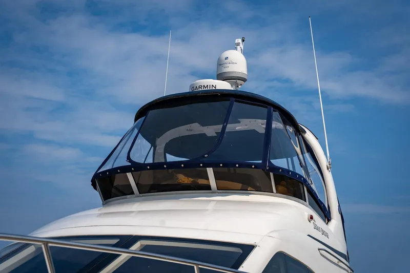Slide: The Image of 2006 Sea Ray 44 Sedan Bridge yacht with Garmin radar against blue sky. - 40