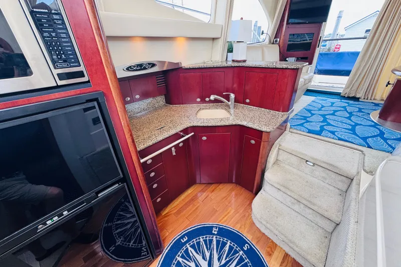 Slide: The Image of Luxurious 2006 Sea Ray 44 Sedan Bridge yacht interior with modern kitchen and elegant design. - 15