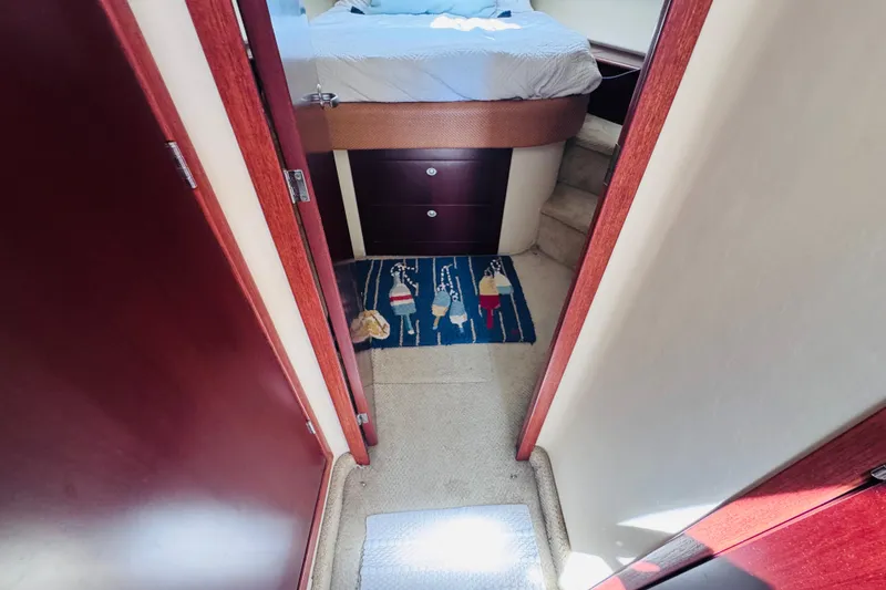 Slide: The Image of Interior view of 2006 Sea Ray 44 Sedan Bridge cabin with bed and nautical-themed rug. - 7