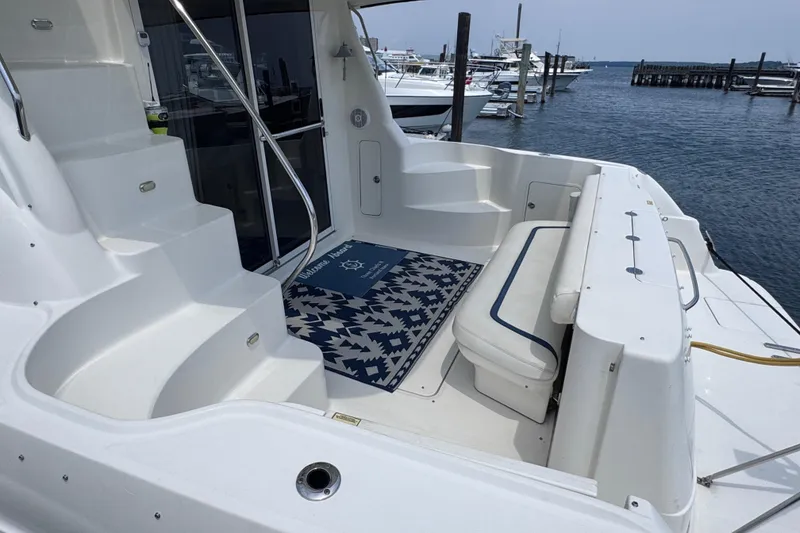 Slide: The Image of 2006 Sea Ray 44 Sedan Bridge yacht deck with seating and marina view. - 42