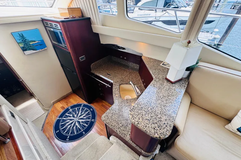 Slide: The Image of Luxurious 2006 Sea Ray 44 Sedan Bridge interior with modern kitchen and elegant design. - 16