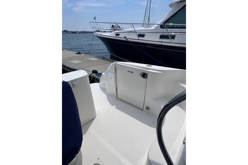 Slide: The Image of 2006 Sea Ray 44 Sedan Bridge yacht docked, showcasing sleek design and spacious deck. - 43