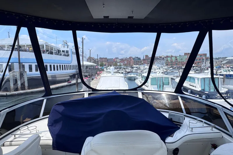 Slide: The Image of Cockpit view from a 2006 Sea Ray 44 Sedan Bridge yacht in a bustling marina. - 30