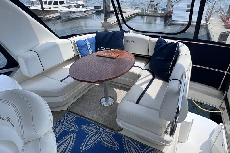 Slide: The Image of Luxurious 2006 Sea Ray 44 Sedan Bridge yacht interior with elegant seating and wooden table. - 34