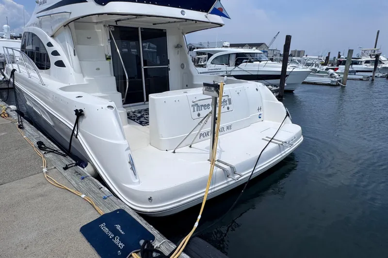 Slide: The Image of 2006 Sea Ray 44 Sedan Bridge yacht docked at marina, rear view. - 44
