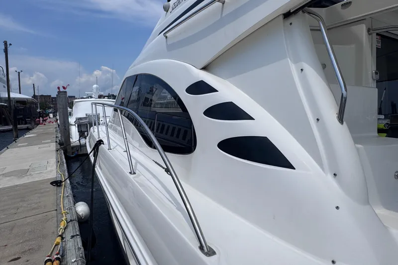 Slide: The Image of 2006 Sea Ray 44 Sedan Bridge yacht docked at marina, showcasing sleek design and modern features. - 41