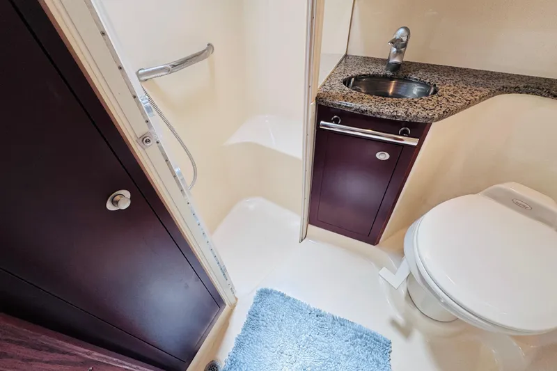 Slide: The Image of Bathroom interior of 2006 Sea Ray 44 Sedan Bridge with shower, sink, and toilet. - 14