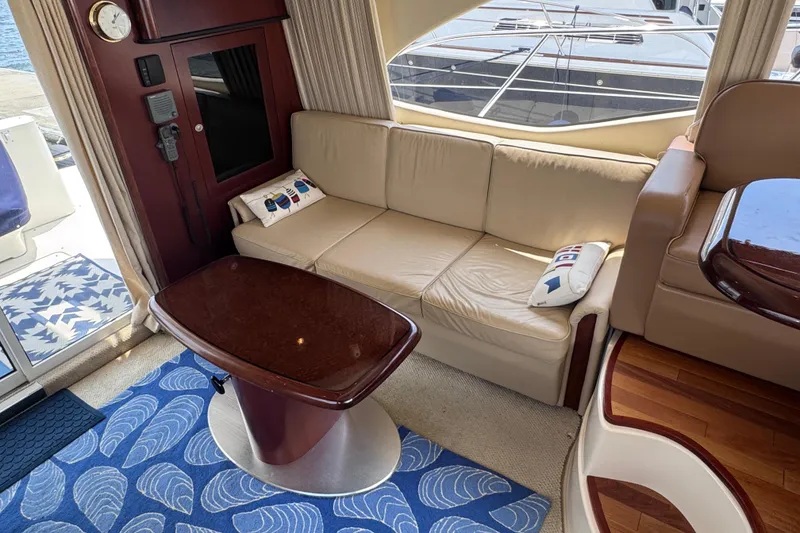 Slide: The Image of Luxurious interior of 2006 Sea Ray 44 Sedan Bridge with beige sofa and elegant wood accents. - 21