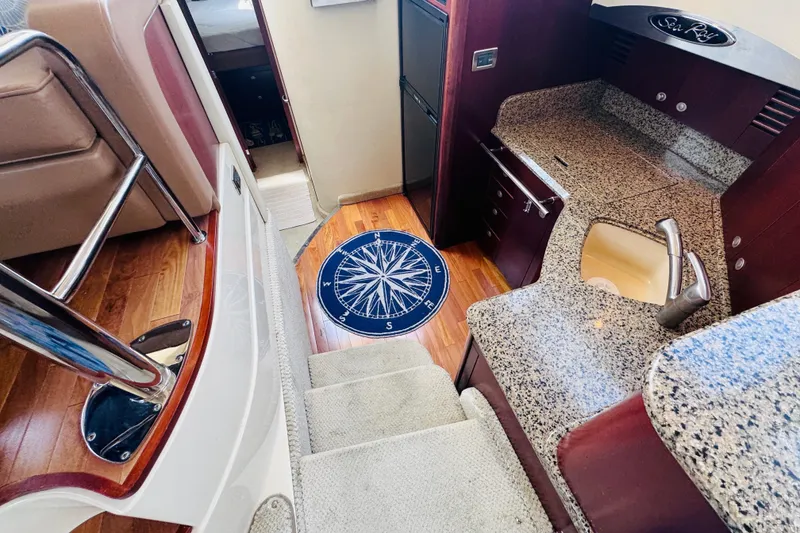 Slide: The Image of Interior of 2006 Sea Ray 44 Sedan Bridge with granite countertops and wooden flooring. - 17