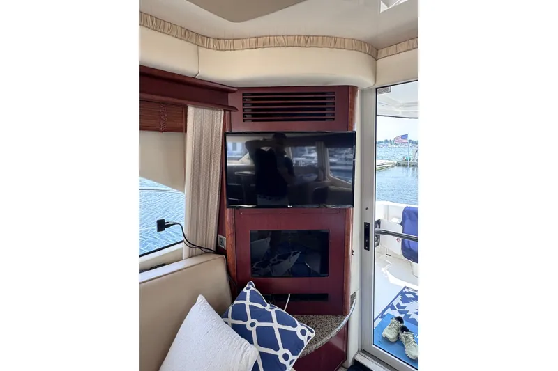 Slide: The Image of Interior of 2006 Sea Ray 44 Sedan Bridge with TV, window view, and cozy seating. - 27