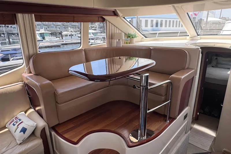 Slide: The Image of Luxurious interior of a 2006 Sea Ray 44 Sedan Bridge yacht with elegant seating and table. - 24