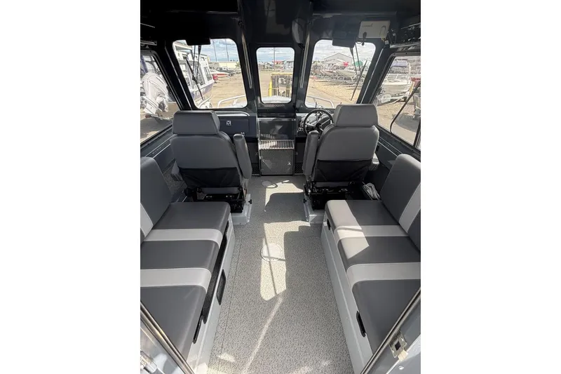 Slide: The Image of 2024 Hewescraft 240 Ocean Pro Hardtop interior with seating and steering wheel. - 4