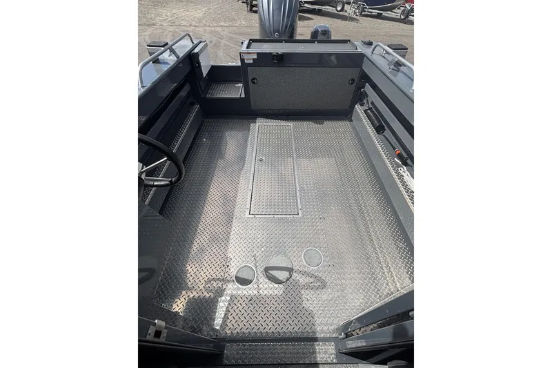 Slide: The Image of 2024 Hewescraft 240 Ocean Pro Hardtop interior with diamond plate flooring and steering wheel. - 8
