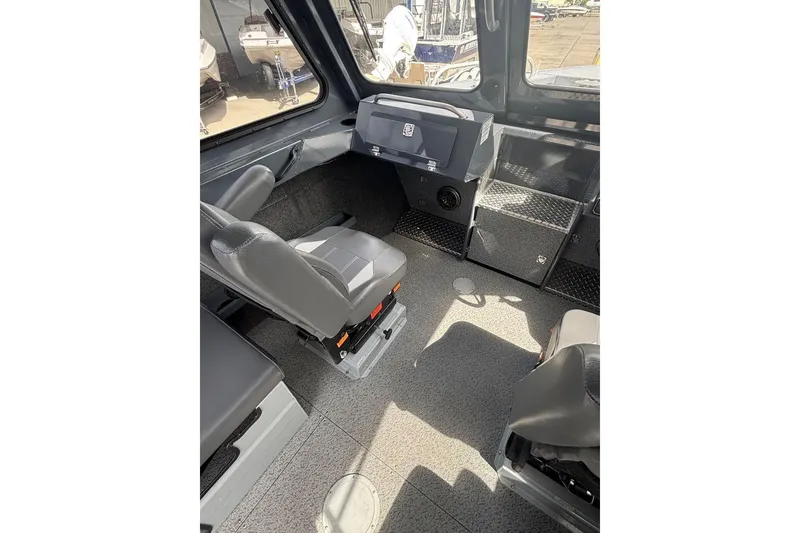 Slide: The Image of Interior of 2024 Hewescraft 240 Ocean Pro Hardtop, featuring helm and seating area. - 6