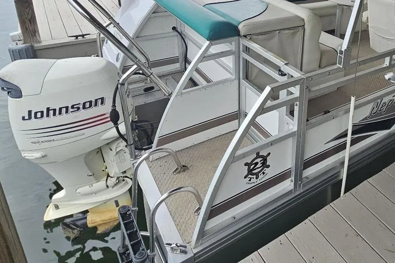 The Image of 2006 JC NepToon 23 TT pontoon boat with Johnson outboard motor at dock. - 1