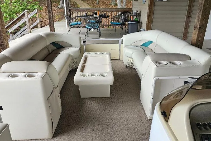 Slide: The Image of Luxurious interior of a 2006 JC NepToon 23 TT pontoon boat with plush seating and cup holders. - 3