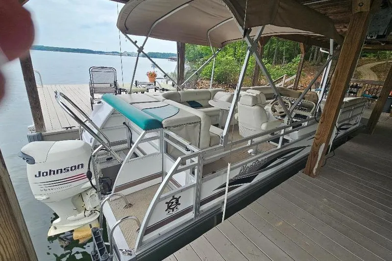 Slide: The Image of 2006 JC NepToon 23 TT pontoon boat docked with Johnson outboard motor. - 6