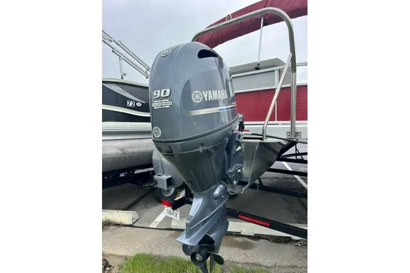 Slide: The Image of 2021 Bennington 205SL with Yamaha 90 outboard motor, parked on a trailer. - 7