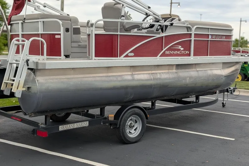 Slide: The Image of 2021 Bennington 205SL pontoon boat on trailer in parking lot. - 4