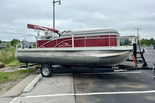 Slide: The Image of 2021 Bennington 205SL pontoon boat on trailer in parking lot. - 6