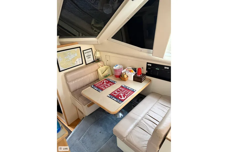 Slide: The Image of 1997 Carver 355 Aft Cabin Motor Yacht interior dining area with cozy seating and decor. - 16