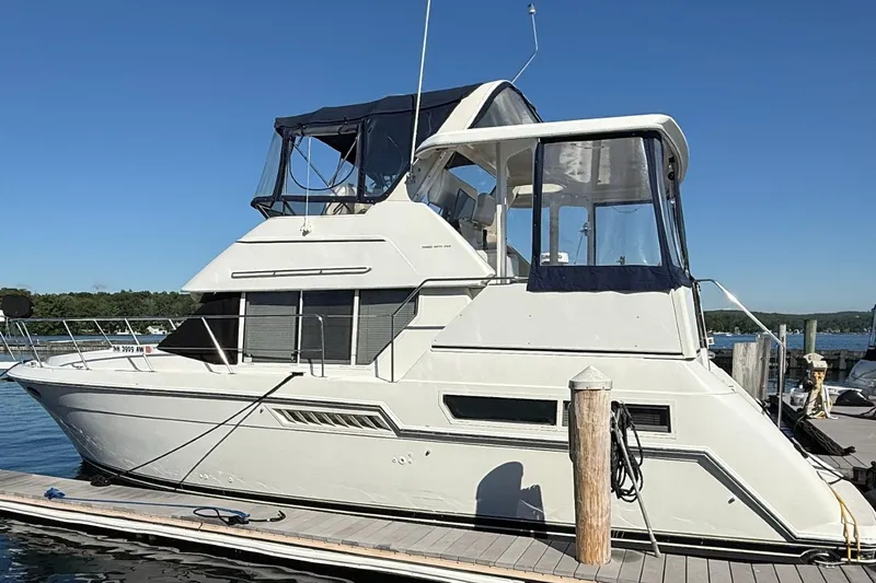 Slide: The Image of 1997 Carver 355 Aft Cabin Motor Yacht docked at marina under clear blue sky. - 3